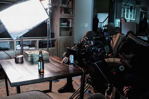 dining table man taking a video on table near studio lamp furniture